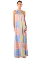 Woman wearing a long, patterned dress on a white background