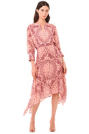 Woman wearing a pink patterned dress on a beige background