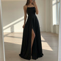 Person wearing a black dress with a high slit in a store setting