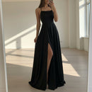Person wearing a black dress with a high slit in a store setting