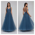 Woman wearing a blue evening gown with a city street background