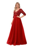 Woman wearing a red evening gown with sequin details in a room.