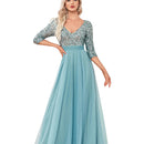 Woman wearing a blue dress with a sequined top in an elegant room.