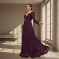 Woman wearing a navy blue evening gown in an elegant interior setting