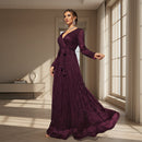 Woman wearing a navy blue evening gown in an elegant interior setting