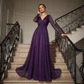 Woman in a purple evening gown standing on a staircase with decorative railings.