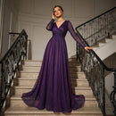 Woman in a purple evening gown standing on a staircase with decorative railings.
